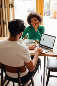 Woman In Green Long Sleeve Shirt Sitting In Front Of A Man